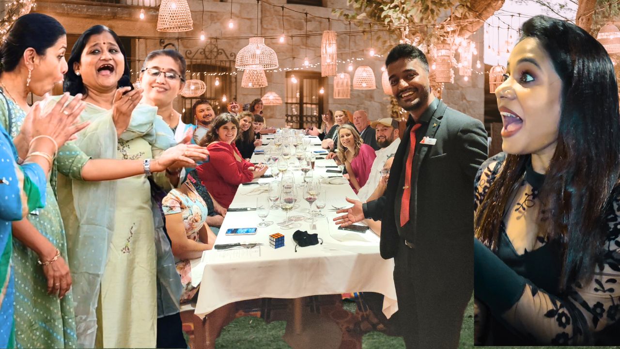 A professional wedding magician in Chennai performing an interactive magic trick for a bride and groom during their wedding reception. The magician, dressed in a stylish blazer, is astonishing the crowd with a blend of close-up illusions and mind-reading effects. The background features joyful wedding guests of all ages laughing and applauding. This vibrant and colorful image captures the essence of modern wedding entertainment in Chennai — fun, unforgettable, and unique.